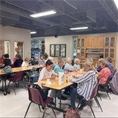 Photo of a room full of senior center members playing bingo together