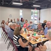 Table full of senior center members enjoying a meal together