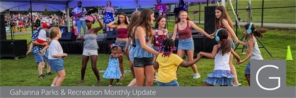 A group of children and teens dancing in front of a stage during the Independence Day Celebration