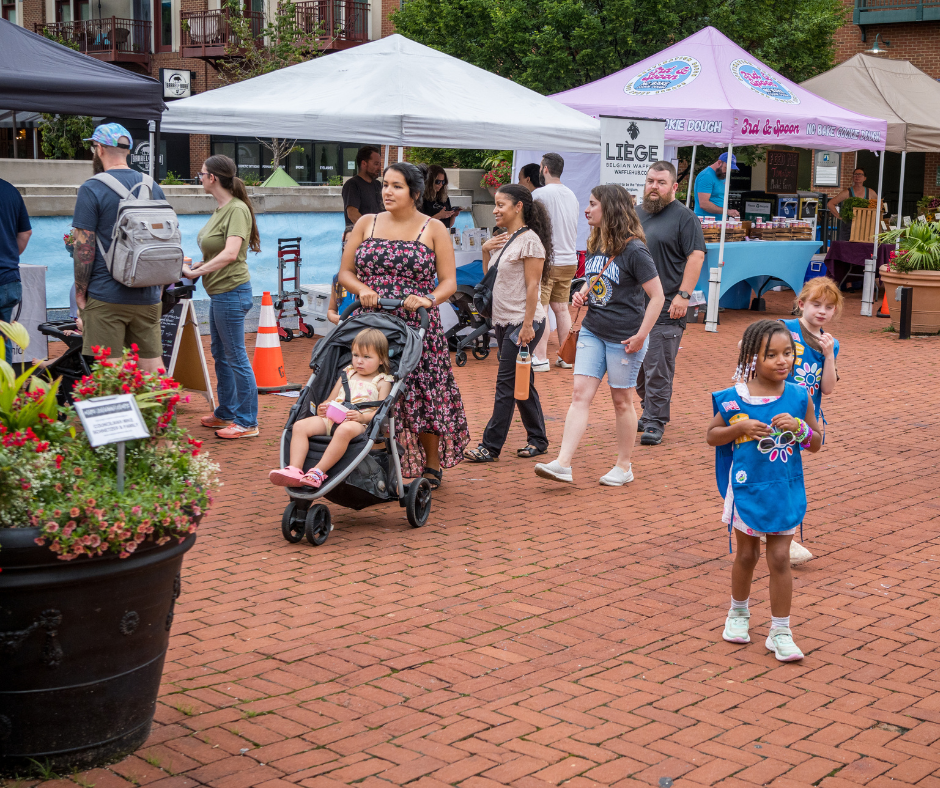 Families walking around vendor booths at the Gahanna Market